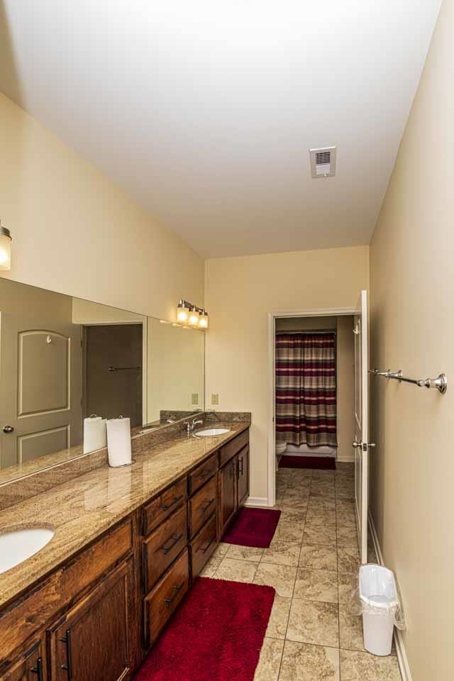 185 Belmont Road Mason, TN 38049 - Photo 28 of 40 a bathroom with a sink a toilet and shower
