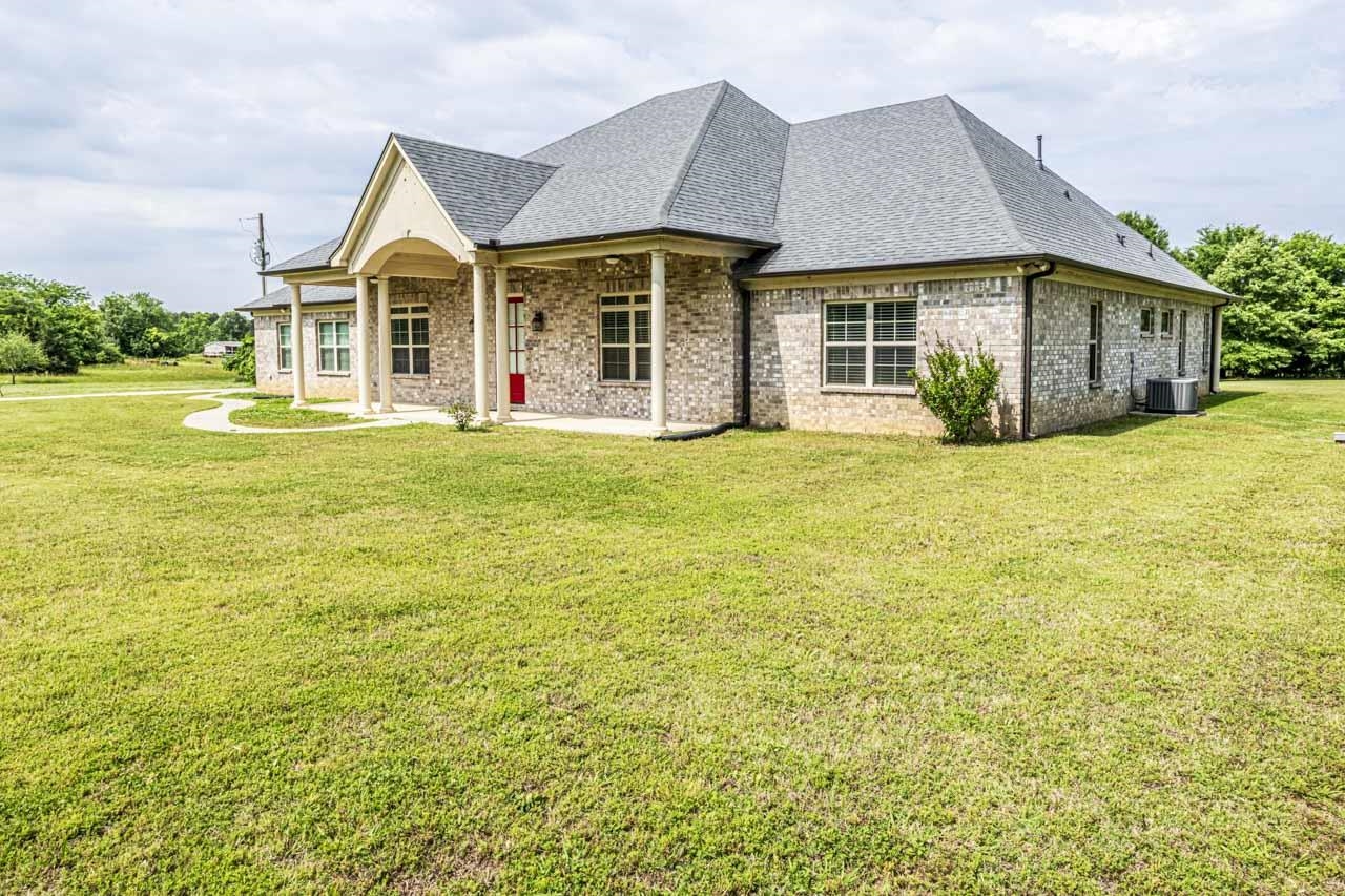 185 Belmont Road Mason, TN 38049 - Photo 38 of 40 a front view of a house with a garden