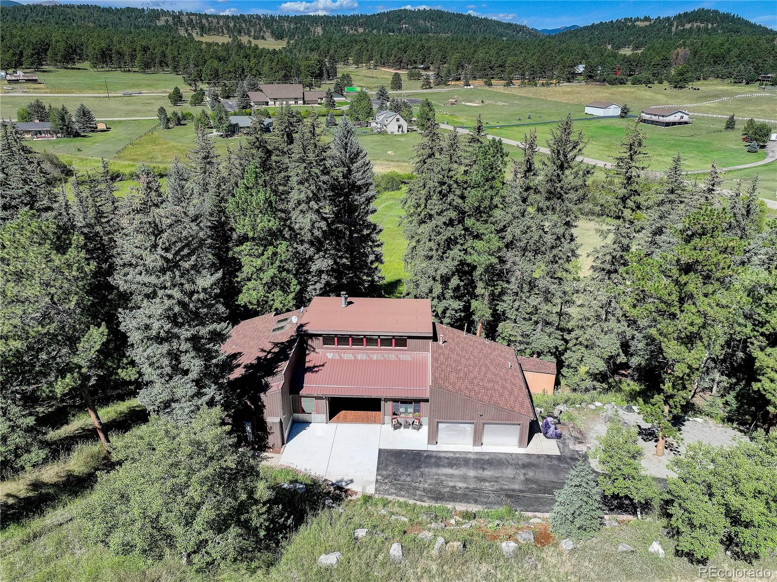 an aerial view of a house with a yard and lake view