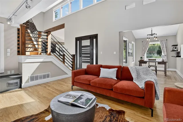 a living room with furniture fireplace and wooden floor