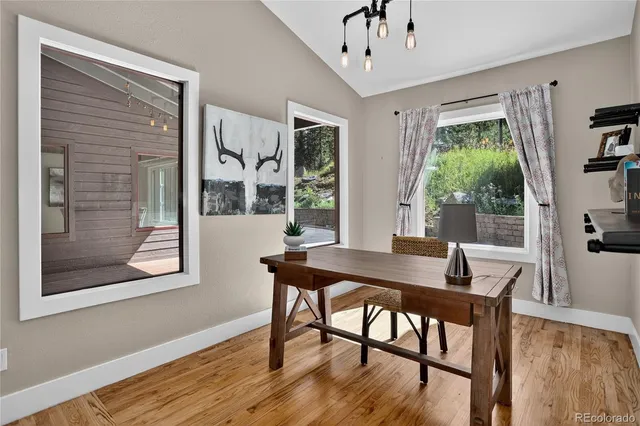 a view of a dining room with furniture window and wooden floor