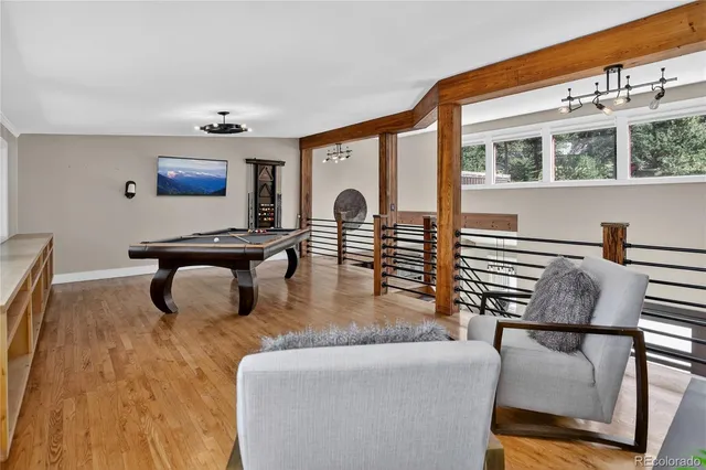 a room with table chairs and a potted plant