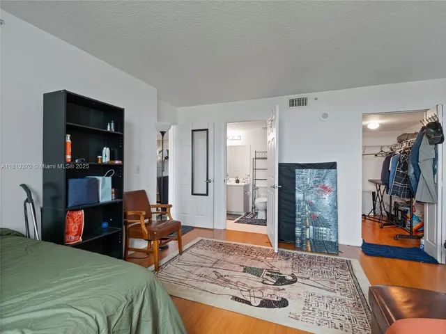 a bedroom with furniture and a rug