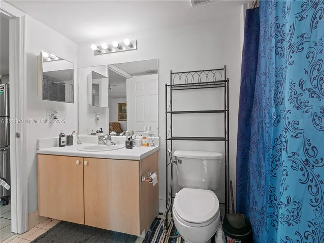 a bathroom with a toilet a sink and mirror