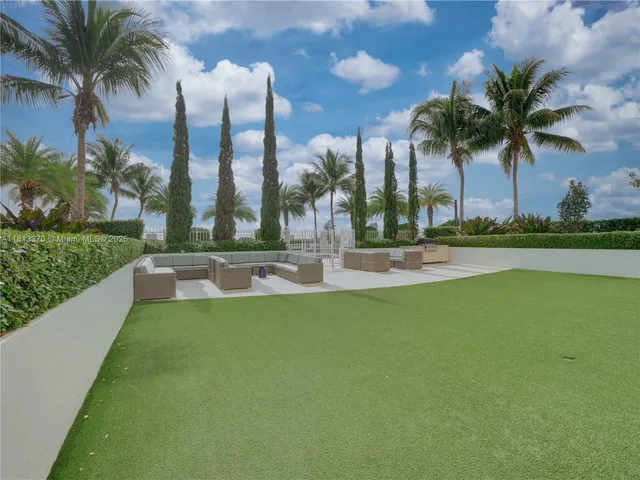 a swimming pool with outdoor seating and yard