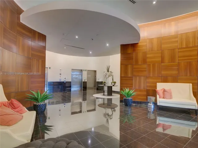 a lobby with furniture and potted plant