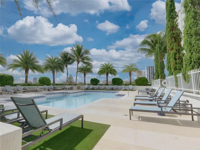 a view of swimming pool with outdoor seating and plants
