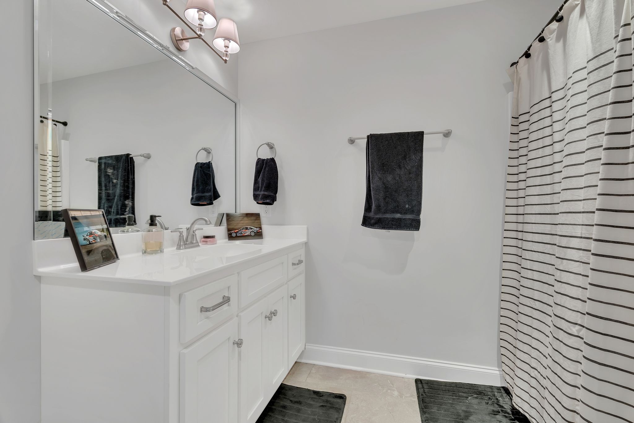 6655 Simmons Bluff Road Lebanon, TN 37090 - Photo 23 of 32 a bathroom with a double vanity sink and mirror