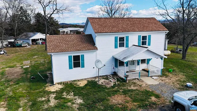a aerial view of a house with a yard and sitting area