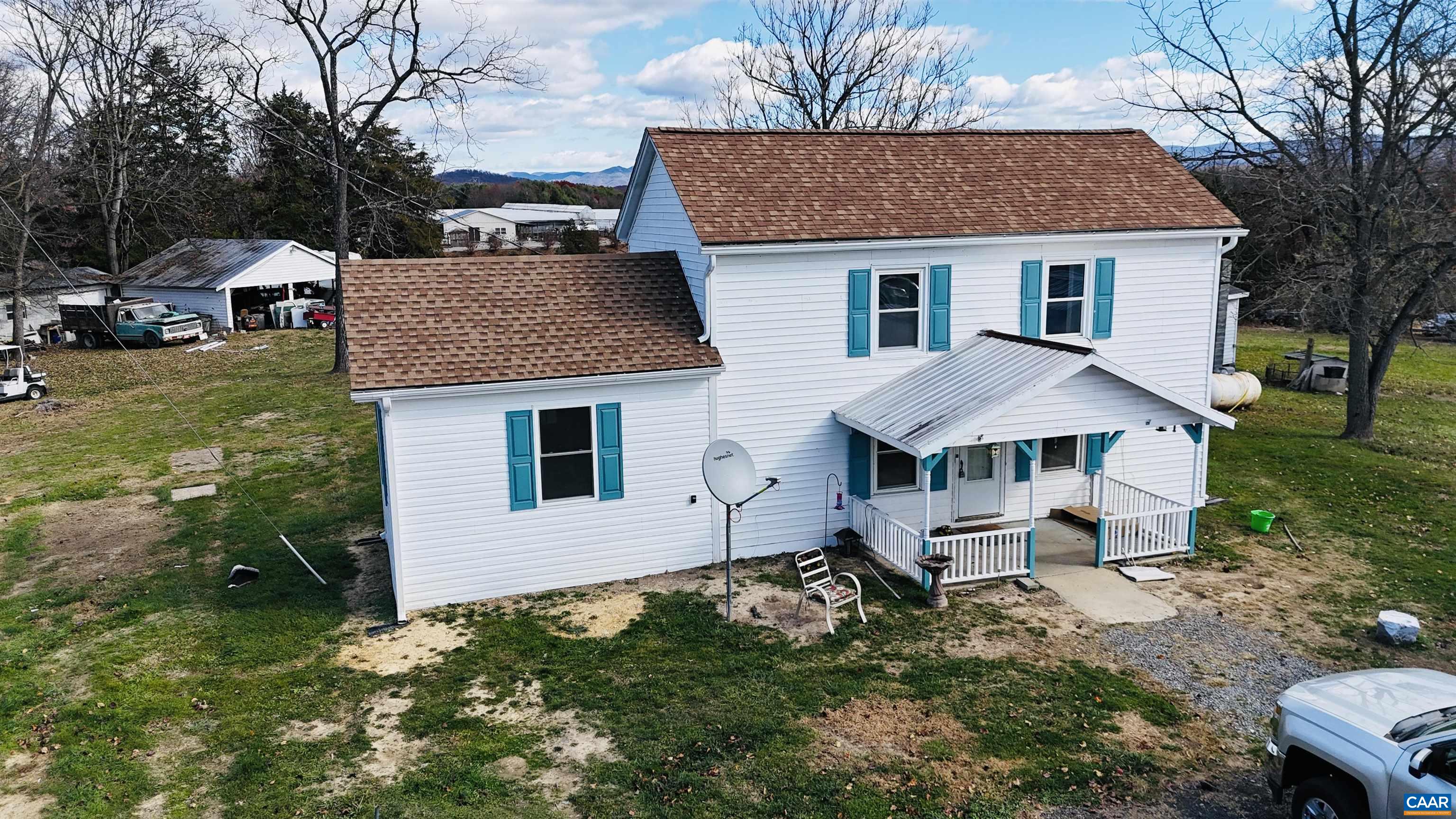 a aerial view of a house with a yard and sitting area