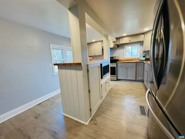 a view of a room with wooden floor and window