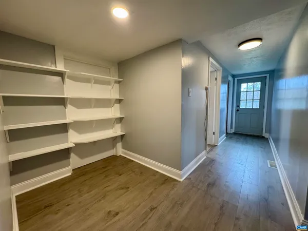 a bathroom with a toilet a sink a mirror a vanity and window