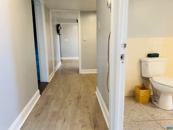 an empty room with closet and a bathroom