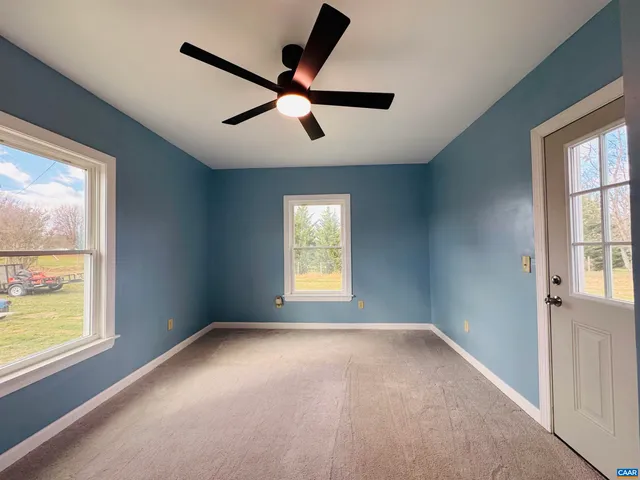 a view of a livingroom with an empty space and a window