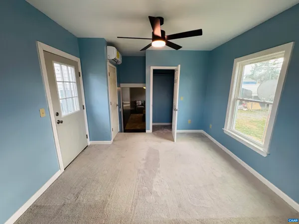 a view of a livingroom with an empty space and a window