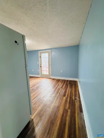 a large kitchen with stainless steel appliances granite countertop a sink and cabinets with wooden floor