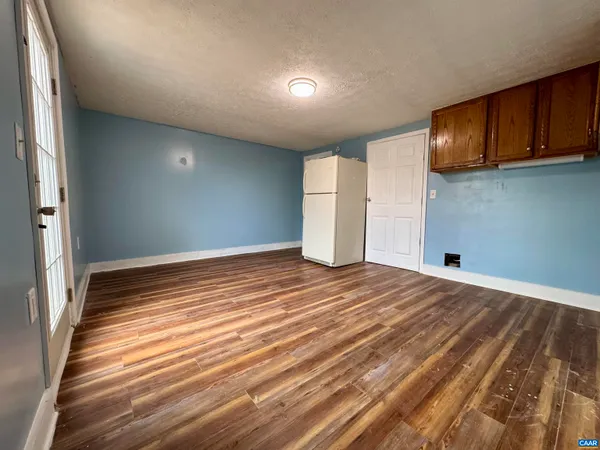 a view of a hallway view with wooden floor and staircase