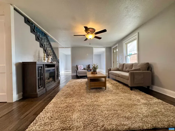a living room with furniture and a chandelier