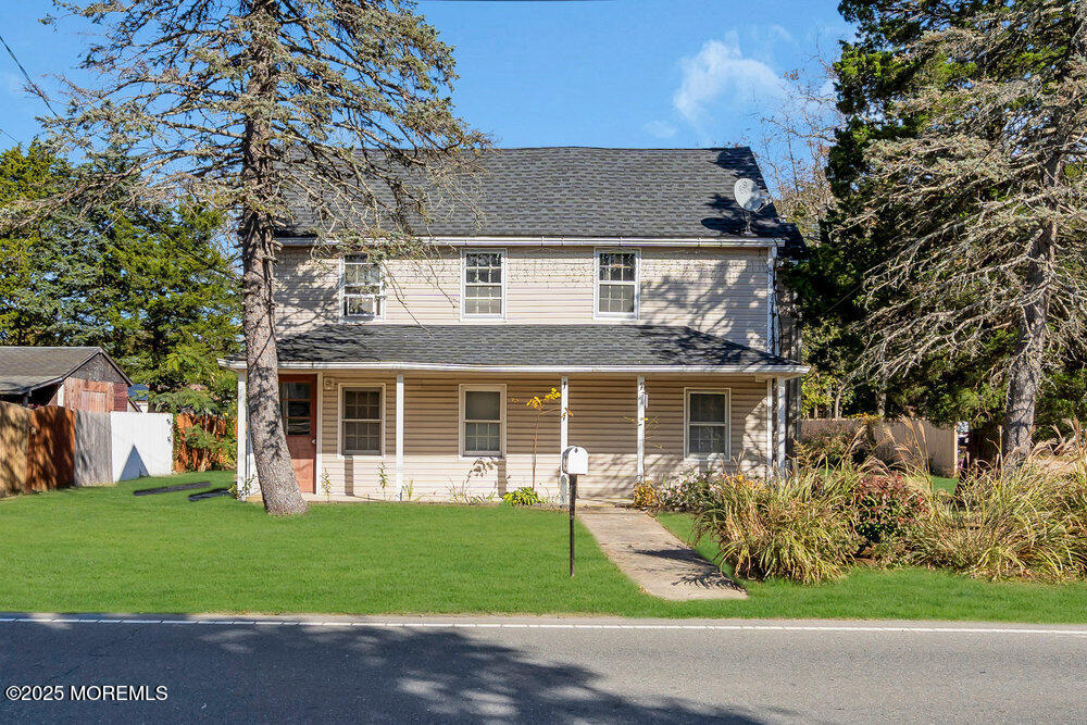 a front view of a house with a garden and plants