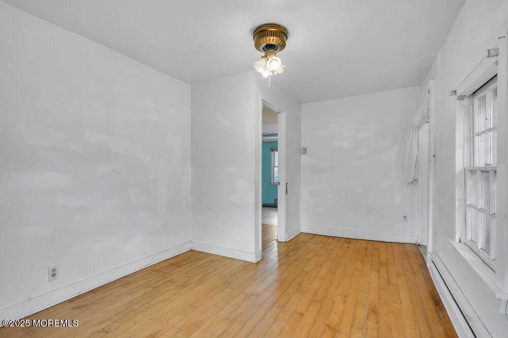 22 Lacey Road Forked River, NJ 08731 - Photo 11 of 24 a view of empty room with wooden floor and fan