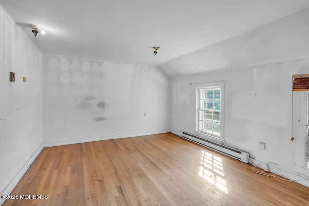 22 Lacey Road Forked River, NJ 08731 - Photo 12 of 24 an empty room with wooden floor and windows