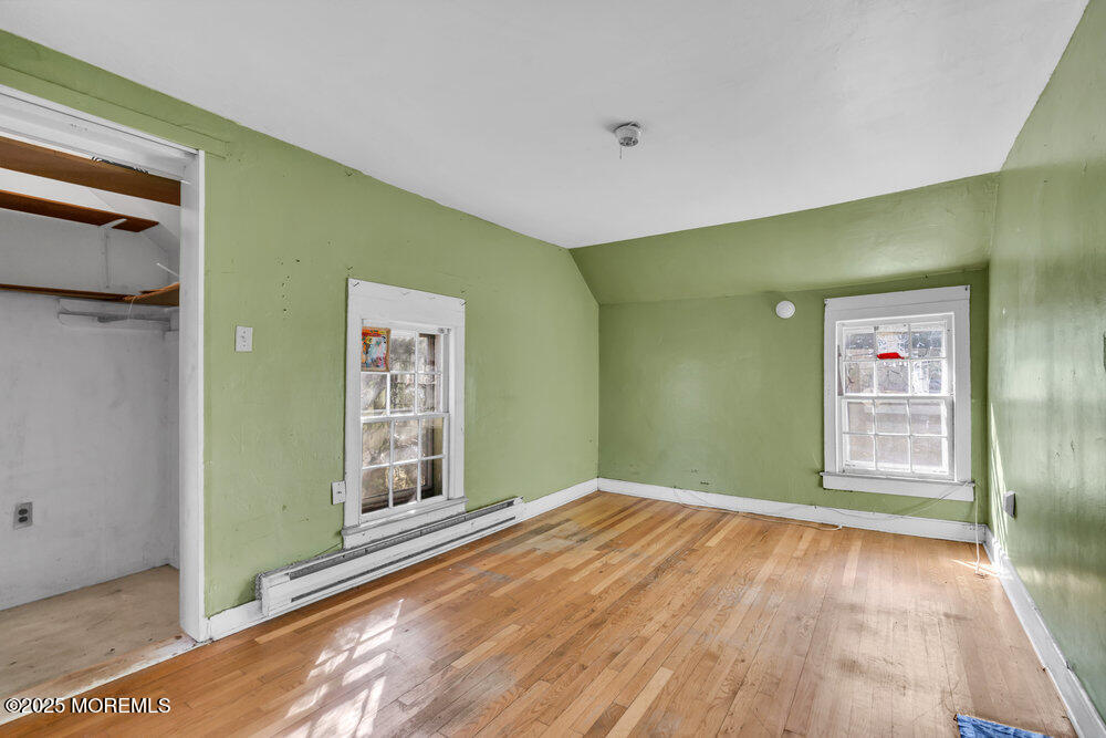 22 Lacey Road Forked River, NJ 08731 - Photo 14 of 24 a view of an empty room with window and wooden floor