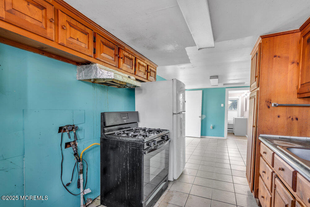 22 Lacey Road Forked River, NJ 08731 - Photo 5 of 24 a kitchen with stainless steel appliances granite countertop a stove and a refrigerator