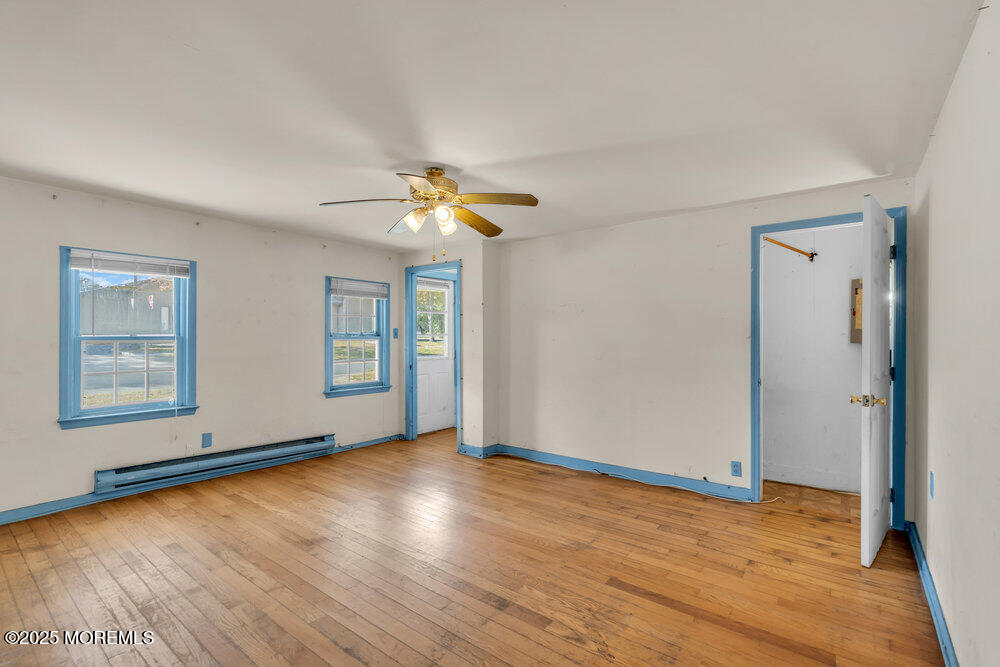 22 Lacey Road Forked River, NJ 08731 - Photo 8 of 24 an empty room with wooden floor and windows