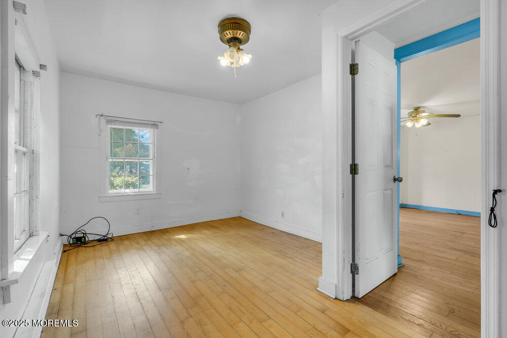 22 Lacey Road Forked River, NJ 08731 - Photo 10 of 24 a view of a room with wooden floor and a window