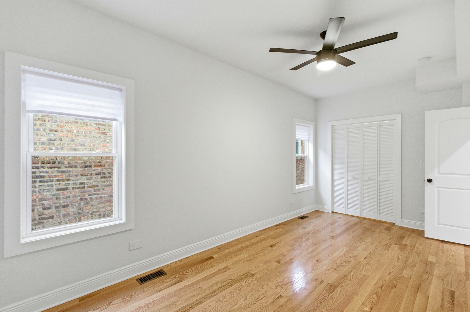 8327 South Morgan Street Chicago, IL 60620 - Photo 12 of 46 a view of a big room with wooden floor closet and windows