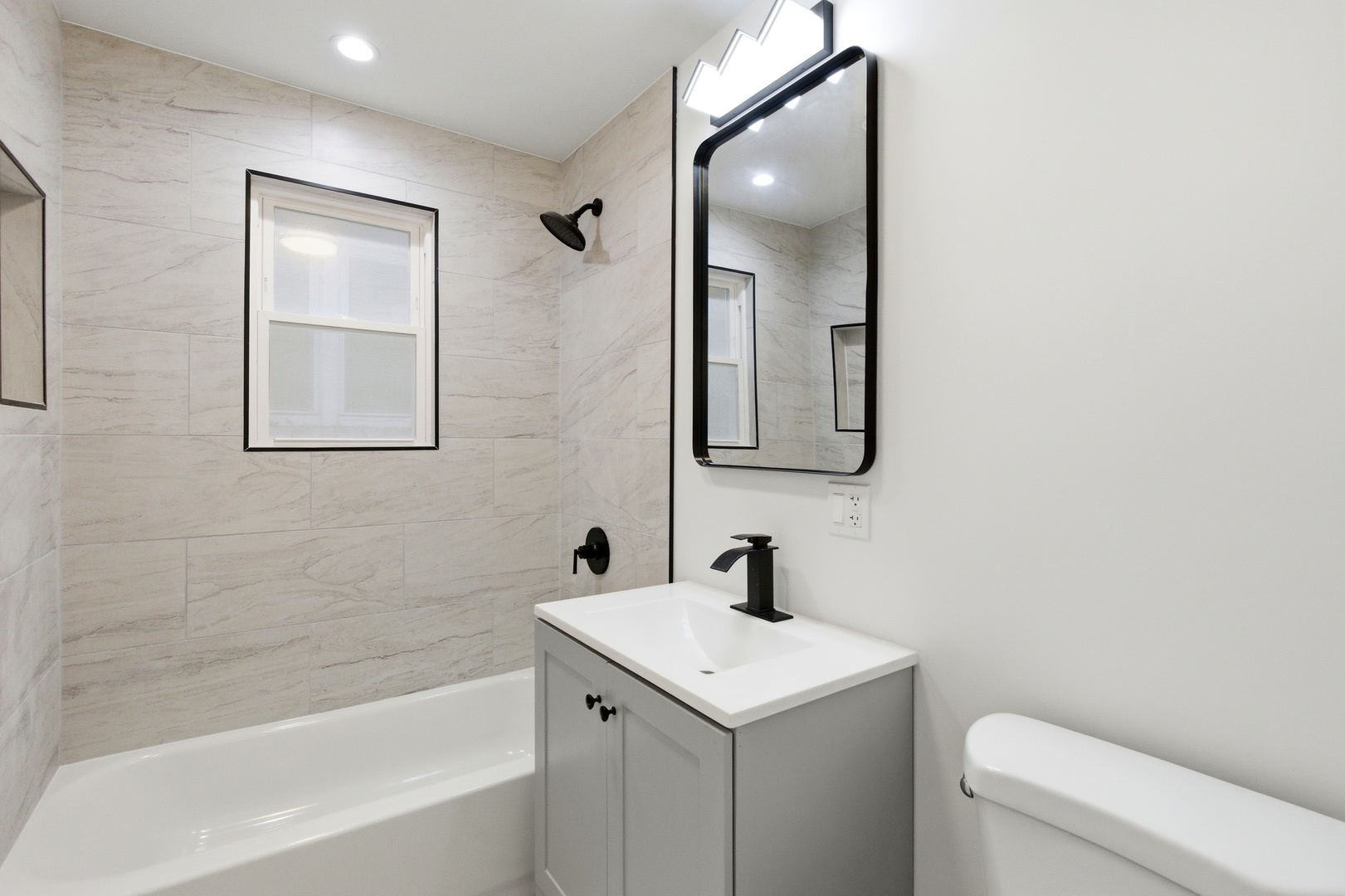 8327 South Morgan Street Chicago, IL 60620 - Photo 15 of 46 a bathroom with a toilet sink and mirror