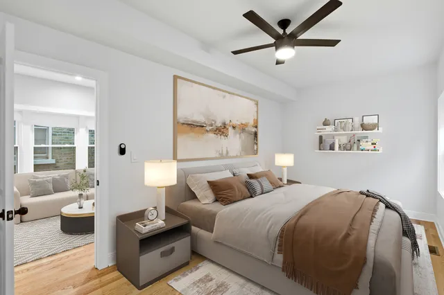 a bedroom with a bed and wooden floor