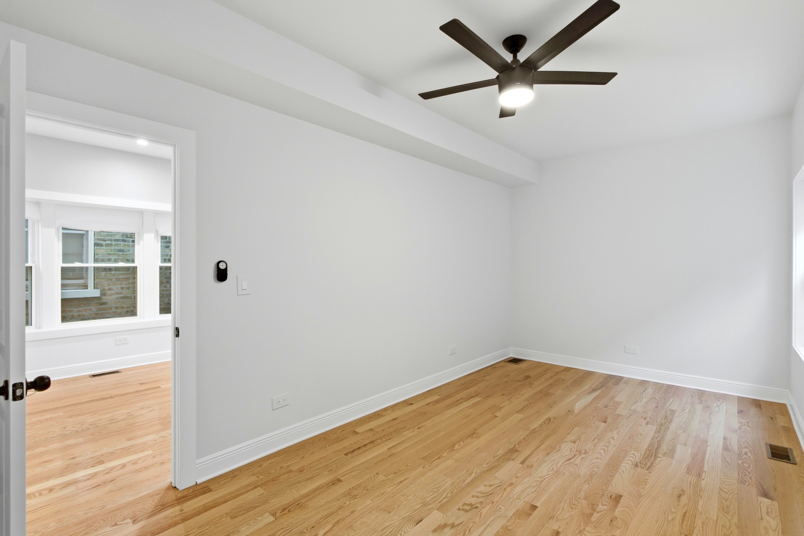 8327 South Morgan Street Chicago, IL 60620 - Photo 30 of 46 a view of empty room with wooden floor and fan