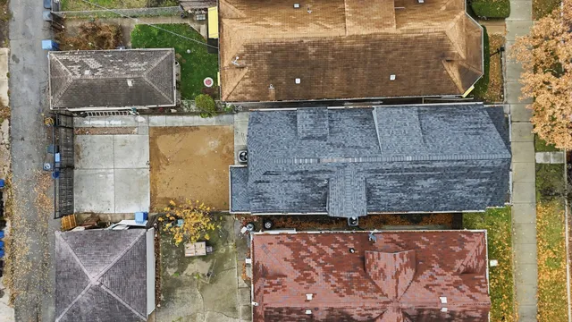 an aerial view of residential houses with city view