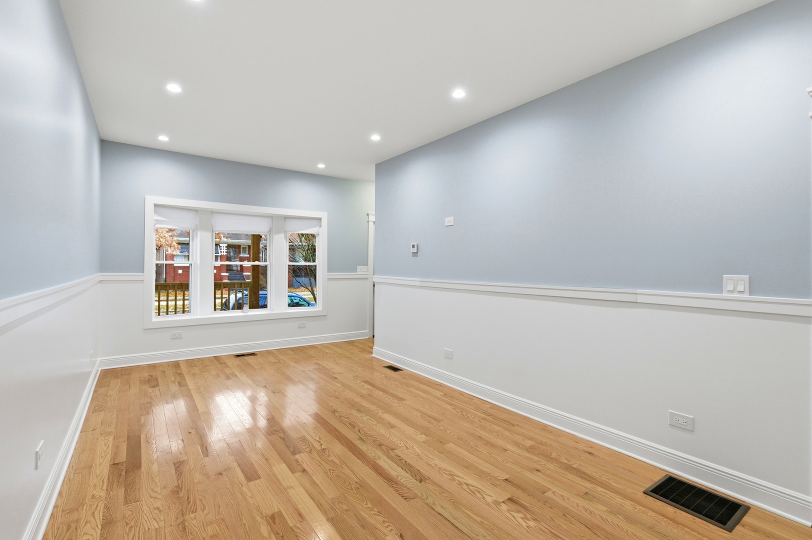 8327 South Morgan Street Chicago, IL 60620 - Photo 10 of 46 a view of an empty room with wooden floor and a window
