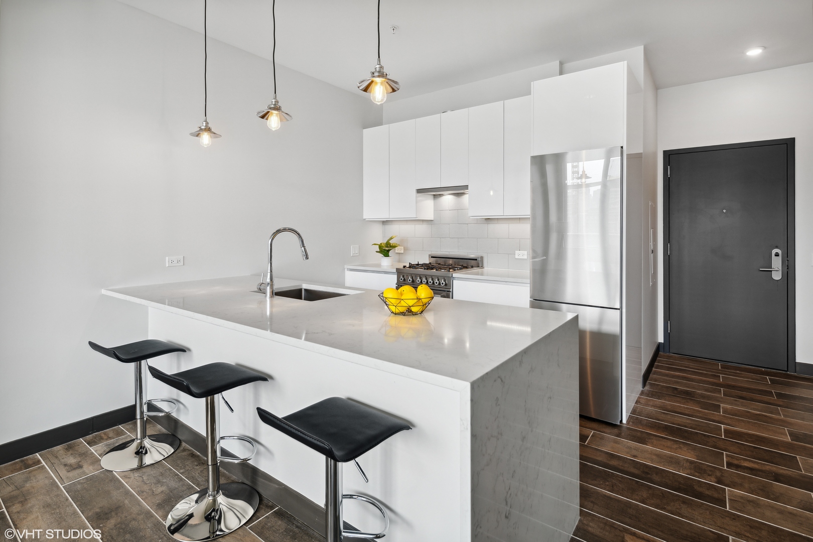 171 North Aberdeen Street, Unit 607 Chicago, IL 60607 - Photo 4 of 20 a kitchen with a sink cabinets and wooden floor