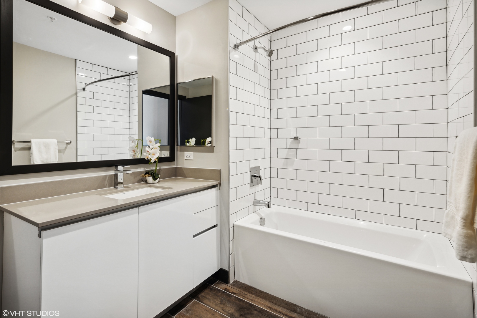 171 North Aberdeen Street, Unit 607 Chicago, IL 60607 - Photo 9 of 20 a bathroom with a granite countertop sink and a bathtub