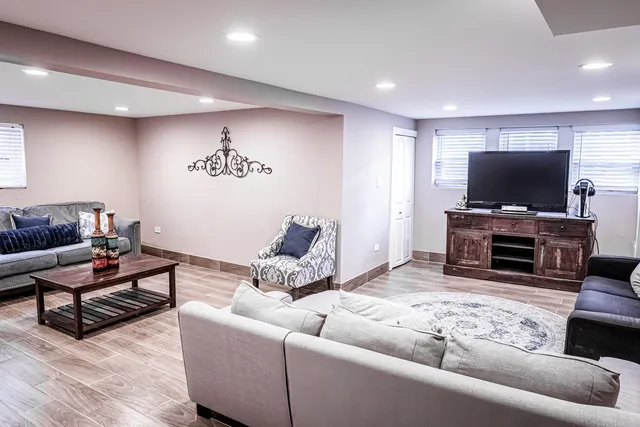 a living room with furniture and wooden floor