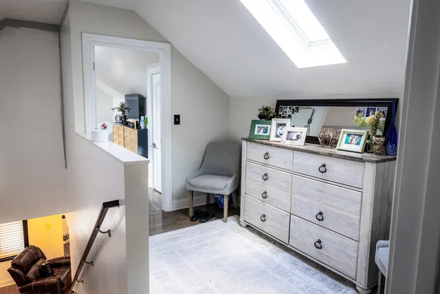 a room with a chair and a view of living room
