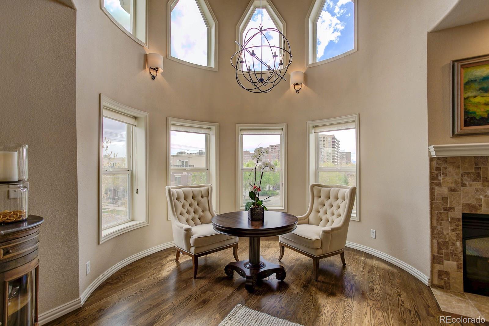 2 Garfield Street, Unit B Denver, CO 80206 - Photo 1 of 24 a dining room with wooden floor a glass table and chairs