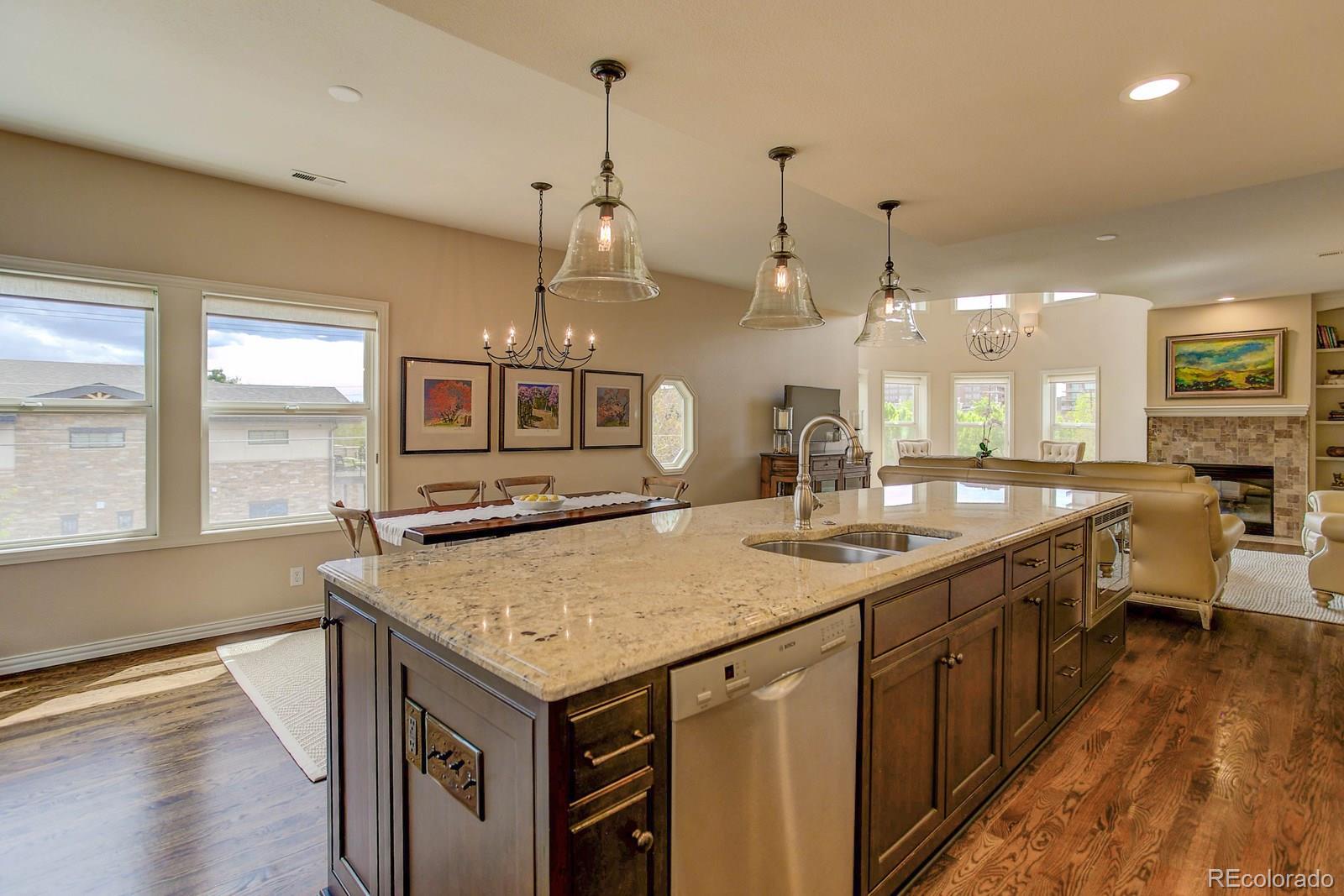 2 Garfield Street, Unit B Denver, CO 80206 - Photo 13 of 24 a kitchen with stainless steel appliances granite countertop a sink a oven a counter top space and a center island
