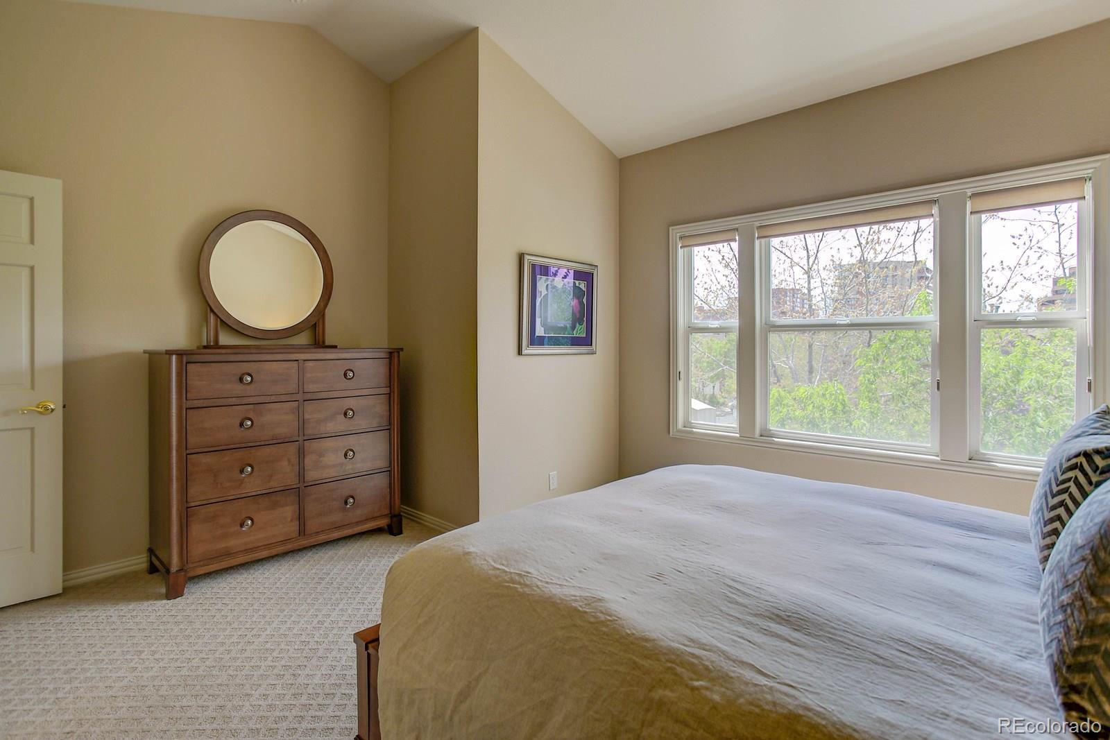 2 Garfield Street, Unit B Denver, CO 80206 - Photo 18 of 24 a spacious bedroom with a bed and a dresser