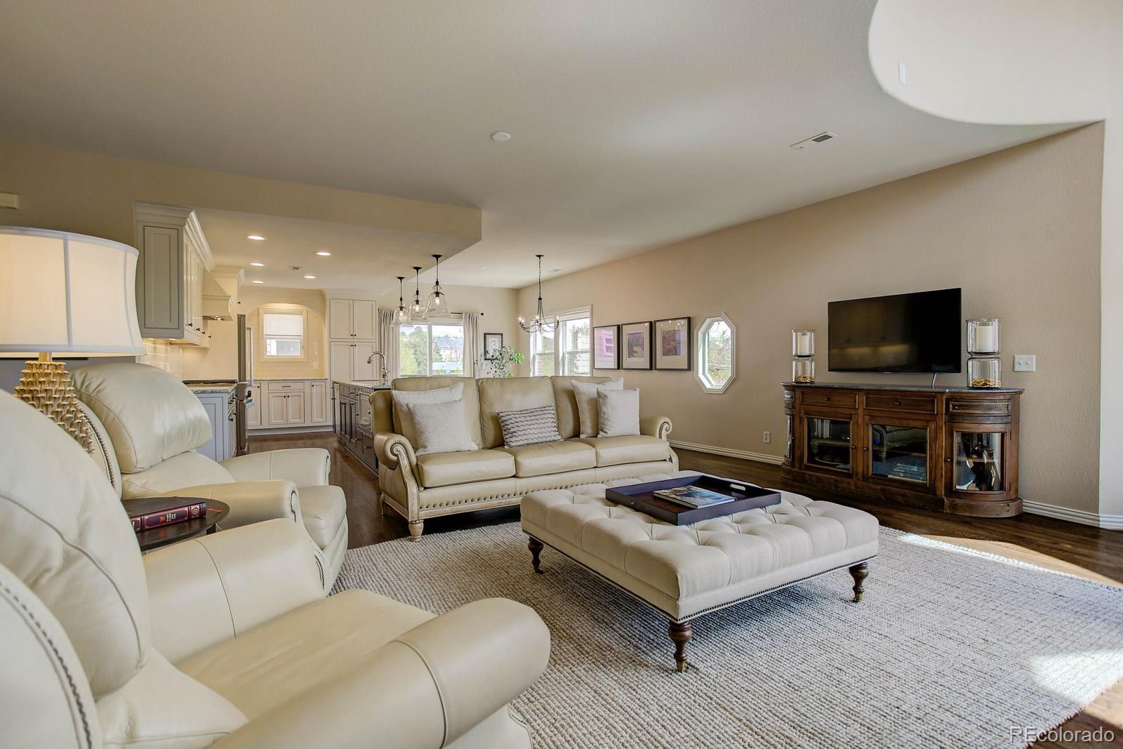 2 Garfield Street, Unit B Denver, CO 80206 - Photo 8 of 24 a living room with furniture and a flat screen tv