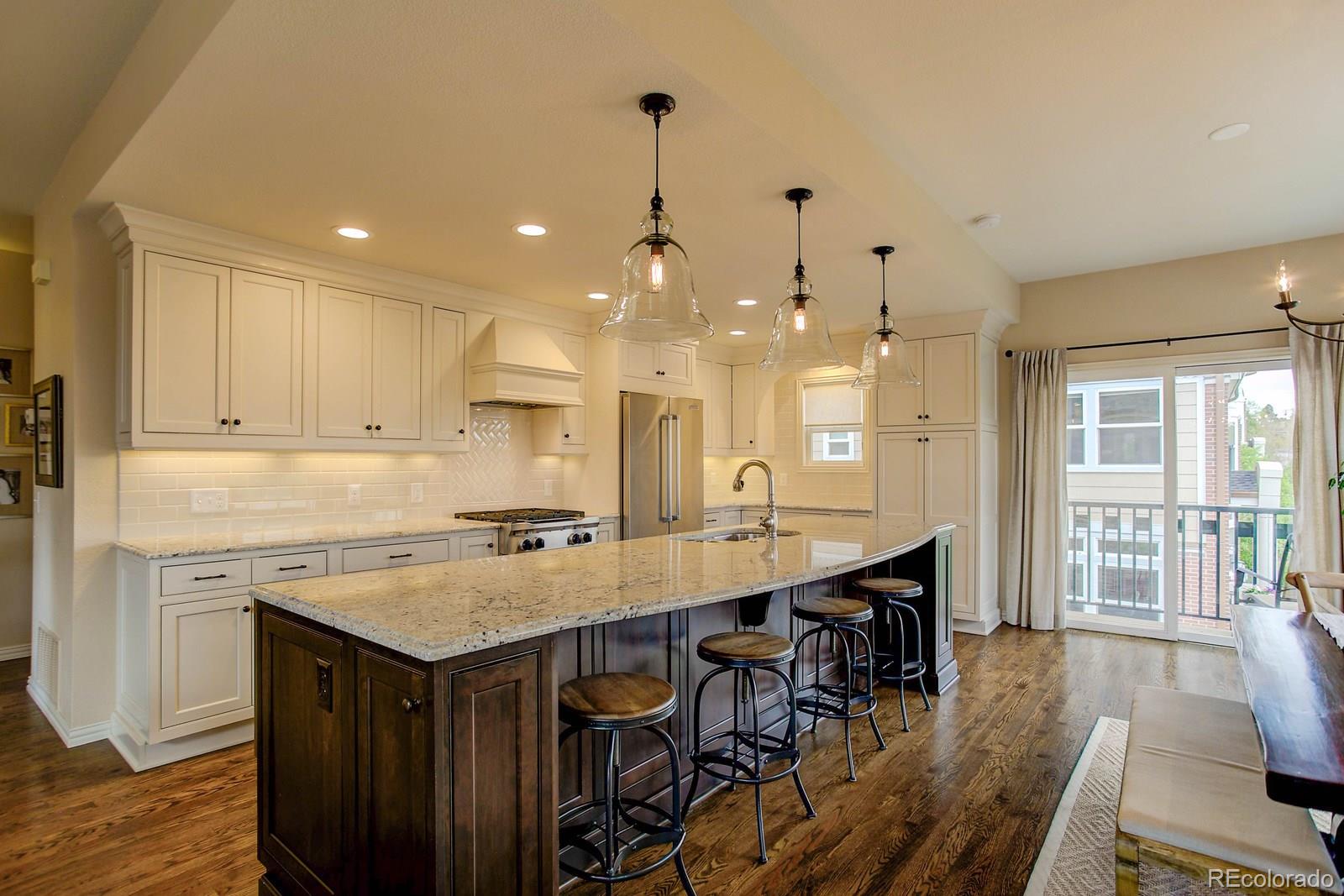 2 Garfield Street, Unit B Denver, CO 80206 - Photo 9 of 24 a kitchen with a table chairs sink and wooden floor
