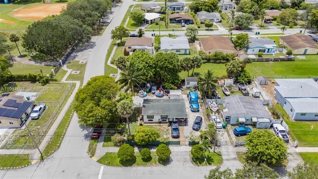 an aerial view of a house with a yard and lake view