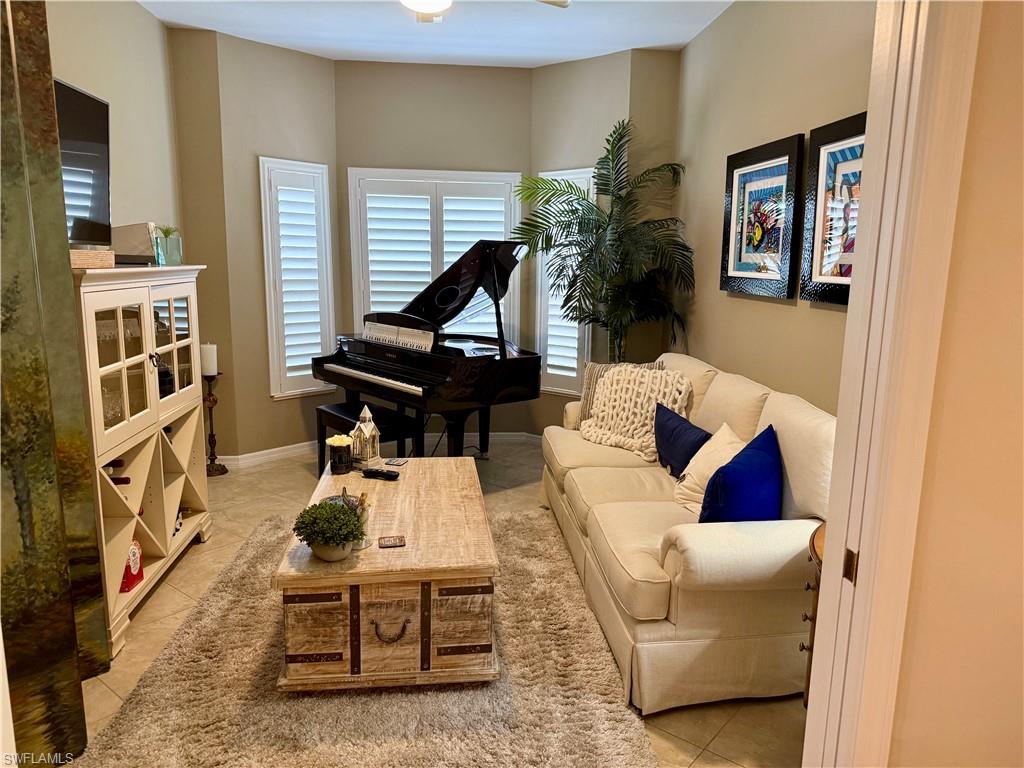 240 Via Perignon, Unit 91 Naples, FL 34119 - Photo 12 of 43 a living room with furniture and a potted plant