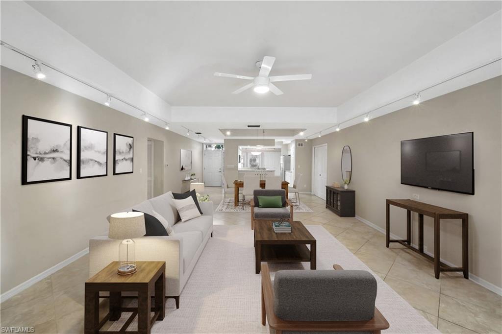 240 Via Perignon, Unit 91 Naples, FL 34119 - Photo 13 of 43 a living room with furniture and a flat screen tv