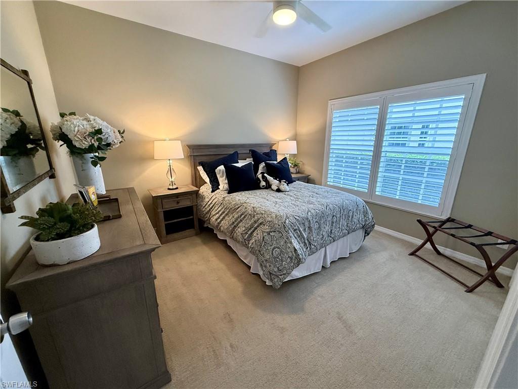 240 Via Perignon, Unit 91 Naples, FL 34119 - Photo 16 of 43 a bedroom with a bed and a dresser