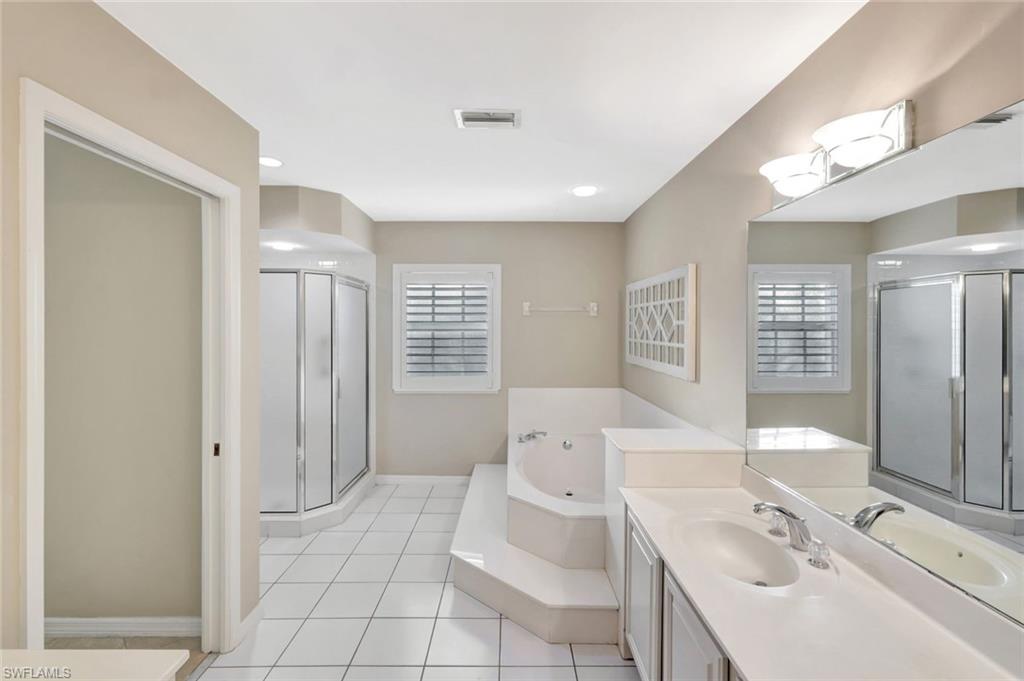 240 Via Perignon, Unit 91 Naples, FL 34119 - Photo 18 of 43 a spacious bathroom with a bathtub sink and toilet