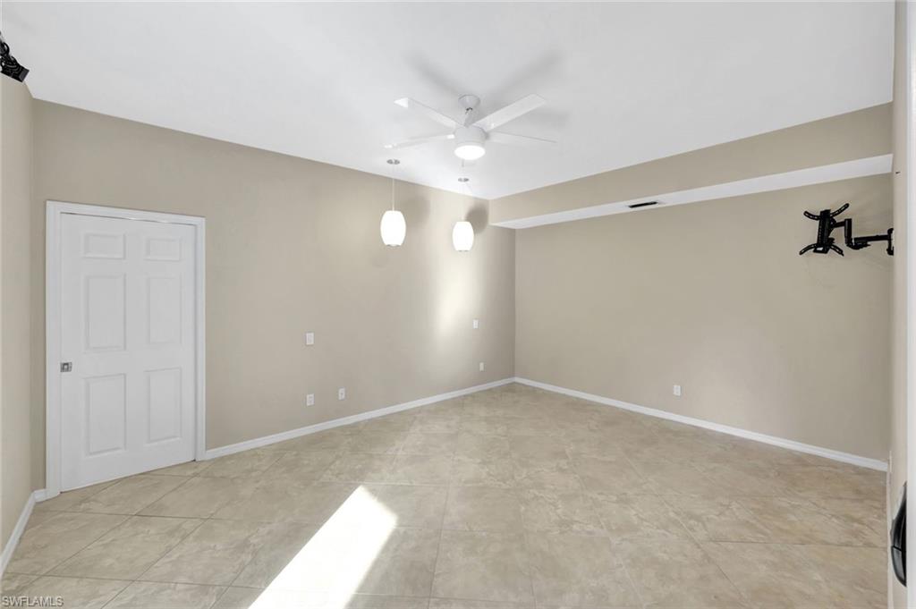 240 Via Perignon, Unit 91 Naples, FL 34119 - Photo 23 of 43 a view of an empty room with a ceiling fan